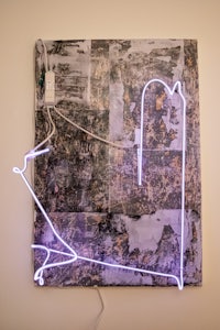 a piece of art with a neon light on it